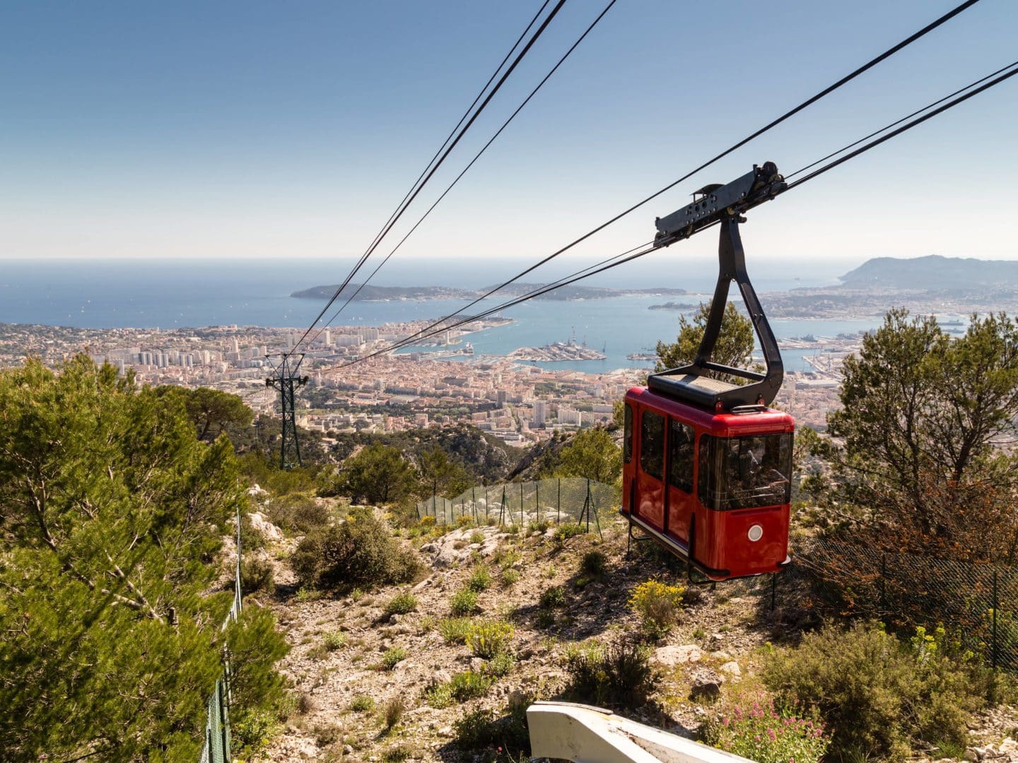 Téléphérique surplombant Toulon et la mer Méditerranée.